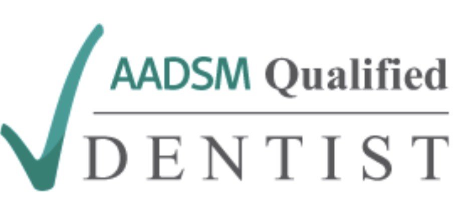 AADSM Qualified Dentist logo featuring a checkmark and the word "DENTIST" in bold letters.